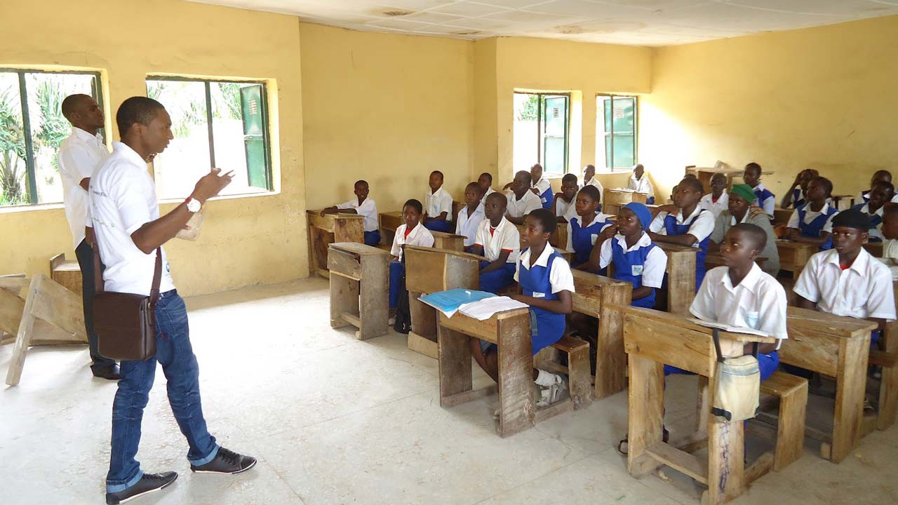 Teacher teaching students in a class in Nigeria
